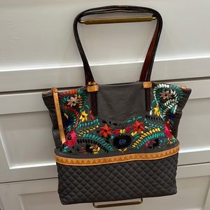 Consuela tote with zipper pocket and embroidered details.